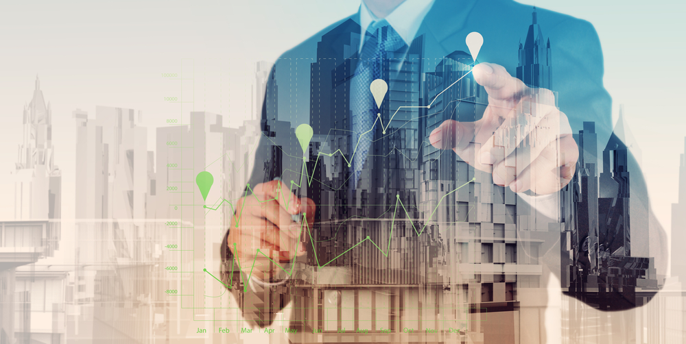 Double exposure of businessman hand working with new modern computer and business strategy as concept